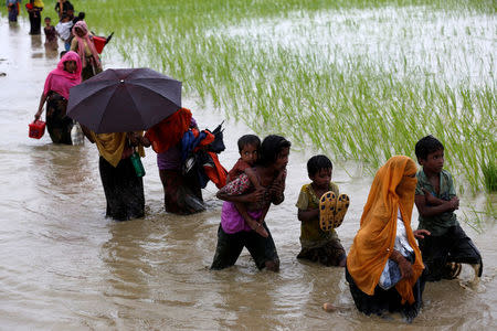 A group of Rohingya refugee people walk in the water after crossing the Bangladesh-Myanmar border in Teknaf, Bangladesh, September 1, 2017. REUTERS/Mohammad Ponir Hossain