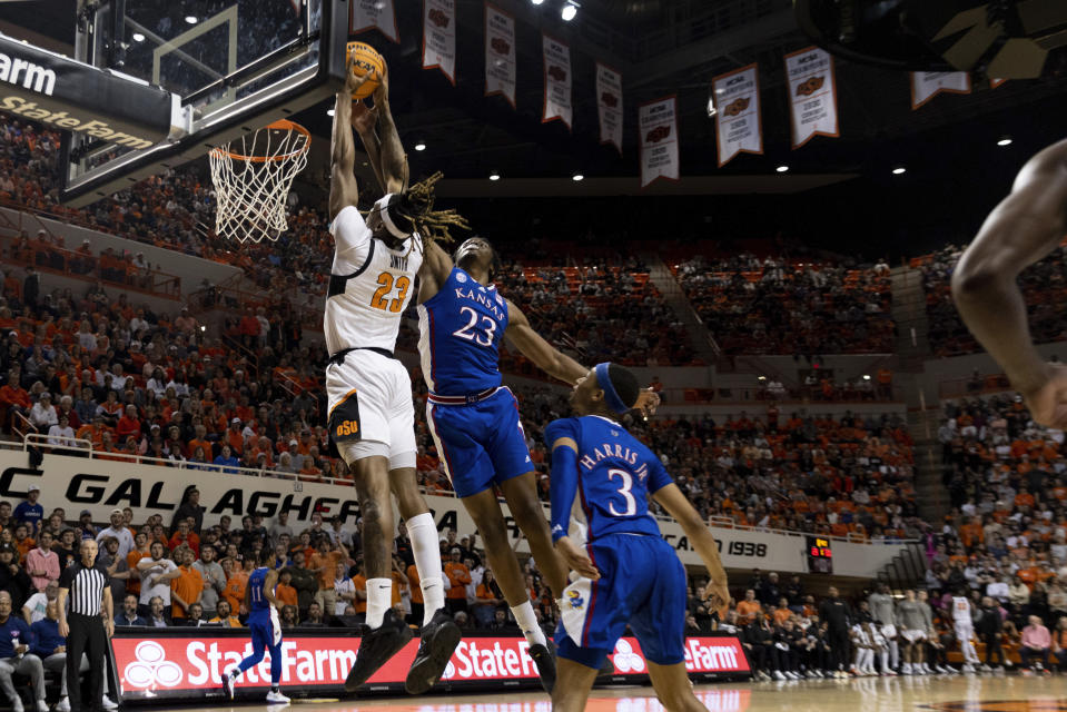 Kansas's Ernest Udeh Jr. (23) blocks Oklahoma State's Tyreek Smith (23) in the first half of an NCAA college basketball game in Stillwater, Okla., Tuesday, Feb. 14, 2023. (AP Photo/Mitch Alcala)