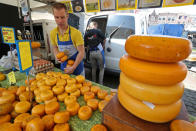 A seller arranges product on a table at the cheese market in Gouda, Netherlands April 18, 2019. REUTERS/Yves Herman