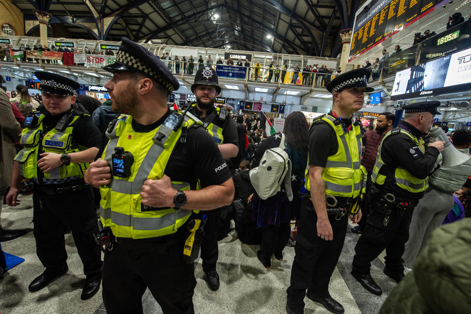 LONDON, ENGLAND - OCTOBER 31: Outnumbered trasport police look on as activists stage a mass sit down protest in Liverpool street station during rush hour to demand a ceasefire and humanitarian aid into Gaza on October 31, 2023 in London, England. (Photo by Guy Smallman/Getty Images)