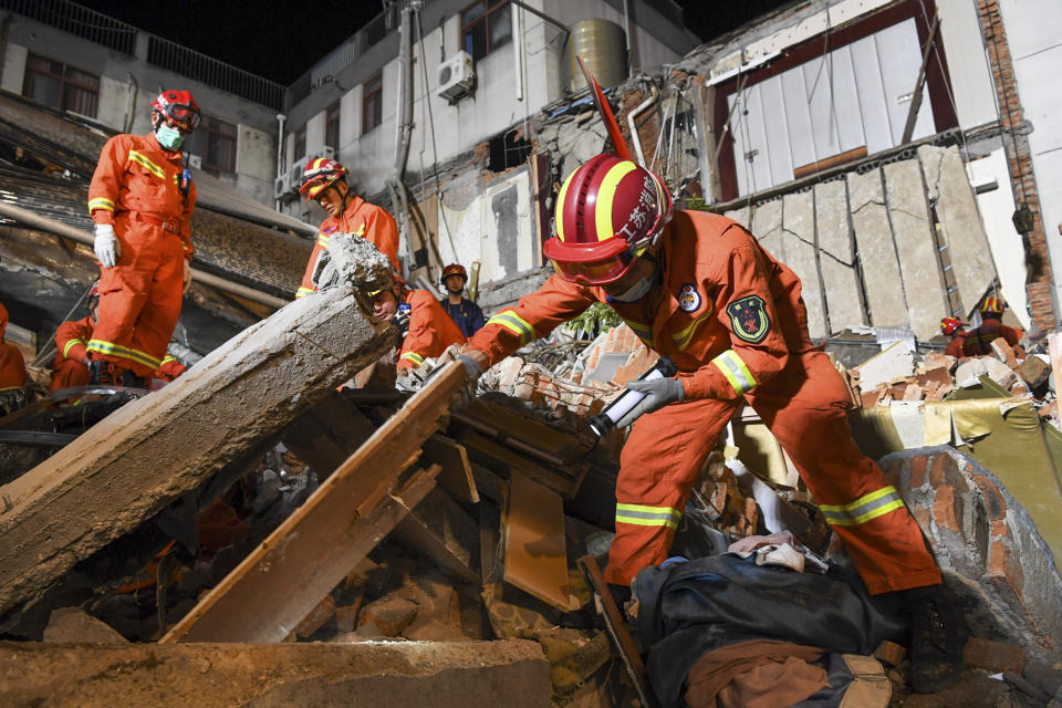 In this photo released by Xinhua News Agency, rescuers search for survivors at a collapsed hotel in Suzhou in eastern China's Jiangsu Province, Monday, July 12, 2021. The hotel building collapsed Monday afternoon. (Li Bo/Xinhua via AP)