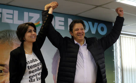 Fernando Haddad (R), former Sao Paulo mayor and member of Workers' Party (PT), and Manuela D'avila of the Communist Party of Brazil (PCdoB) pose before a media conference in Sao Paulo, Brazil August 7, 2018. REUTERS/Paulo Whitaker