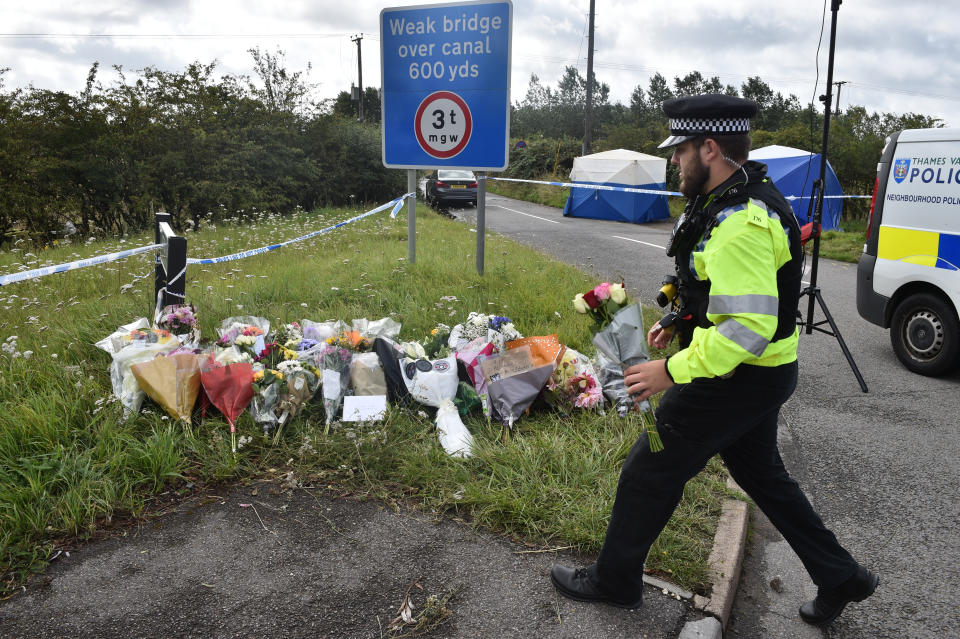 A police officer lays a floral tribute at the scene, where Thames Valley Police officer Pc Andrew Harper, 28, died following a "serious incident" at about 11.30pm on Thursday near the A4 Bath Road, between Reading and Newbury, at the village of Sulhamstead in Berkshire.