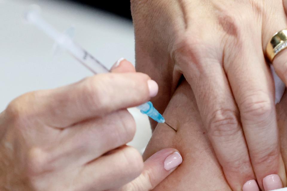 An Israeli medical worker receives a Covid-19 vaccine jab at the Sheba Medical Center, the country's largest hospital, in Ramat Gan near the coastal city of Tel Aviv, on December 19, 2020. (Photo by JACK GUEZ / AFP) (Photo by JACK GUEZ/AFP via Getty Images)