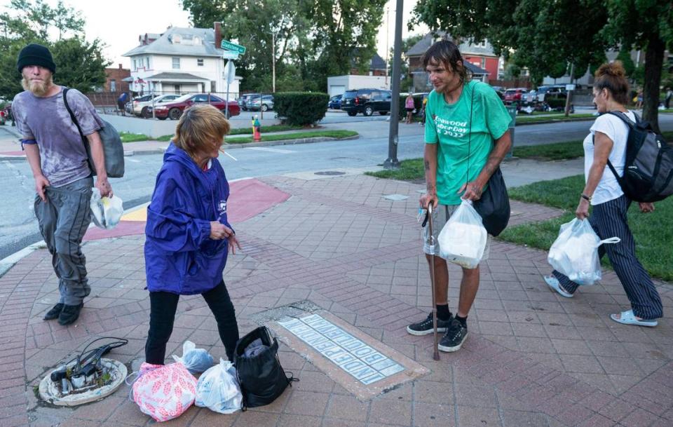 Josephine Kelly Crothers, center left, talks with Chris Culp during Monday Night Church at the Independence Boulevard Christian Church. Culp goes to the church every Monday for food, clothing, and physical therapy with Care Beyond the Boulevard. Zachary Linhares/zlinhares@kcstar.com