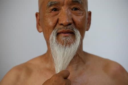 Kung Fu master Li Liangui touches his beard as he demonstrates Suogugong Kung Fu skills for the camera at his apartment in Beijing, China, July 2, 2016. REUTERS/Kim Kyung-HoonREUTERS/Kim Kyung-Hoon