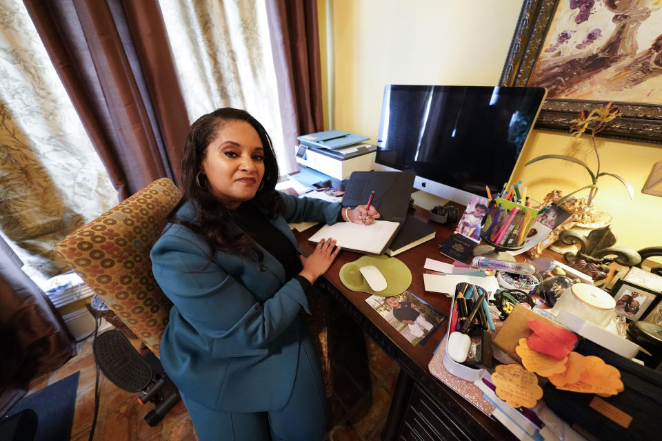 Ashley K. Shelton, executive director of Power Coalition for Equity & Justice in Louisiana, a voter advocacy organization that is trying to get left-leaning voters engaged for next year's elections, possess for a photo at her family home in Baton Rouge, La., Tuesday, Dec. 26, 2023. (AP Photo/Gerald Herbert)