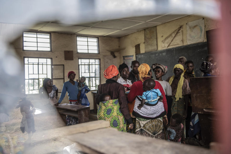 People fleeing the fighting between M23 forces and the Congolese army find refuge in a church in Kibumba, north of Goma, Democratic Republic of Congo, Friday Jan. 28, 2022. In the past week, inhabitants from six villages in the country's east – including, Bukima, Nyesisi, and Ruhanga – have fled the violence. At least 2,000 people are now living in improvised shelters, in churches, schools or with host families. (AP Photo/Moses Sawasawa)