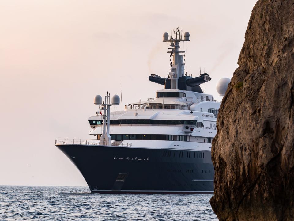 The Octopus on a body of water sailing past rock formations.