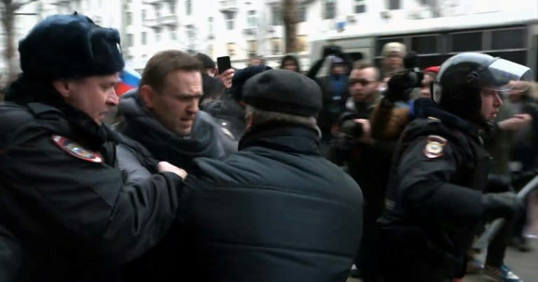 Alexei Navalny has been banned from running for president and was detained at a rally urging voters to boycott the vote