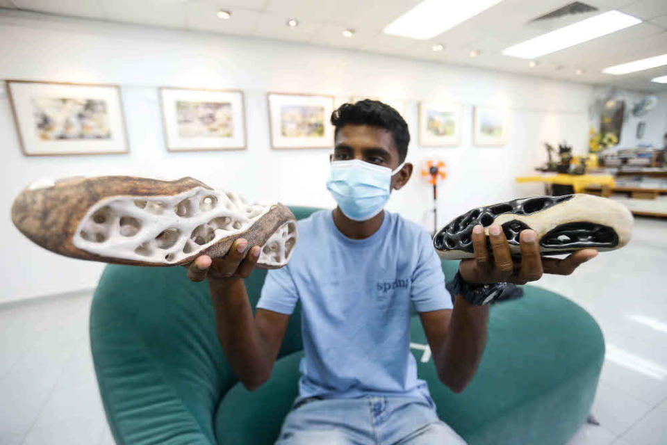 K. Thanesh shows two of his sculptures during an interview regarding his work being previewed here at The Art Gallery, Pulau Tikus October 15, 2021.