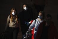 Travelers wearing protective masks arrive at the Ben Gurion Airport, near Tel Aviv, Israel, Thursday, Feb. 27, 2020. (AP Photo/Ariel Schalit)