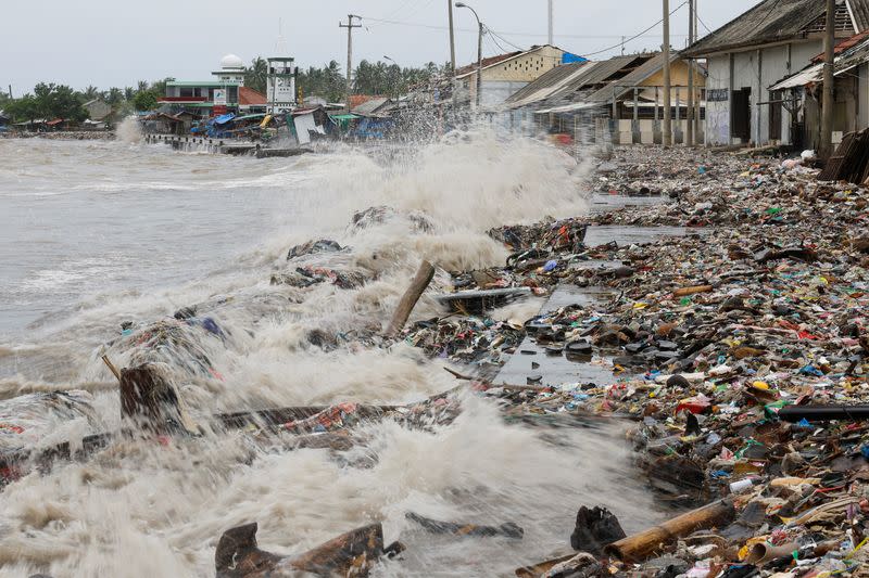 Indonesian fishing village grapples with piles of trash amid erratic high tides