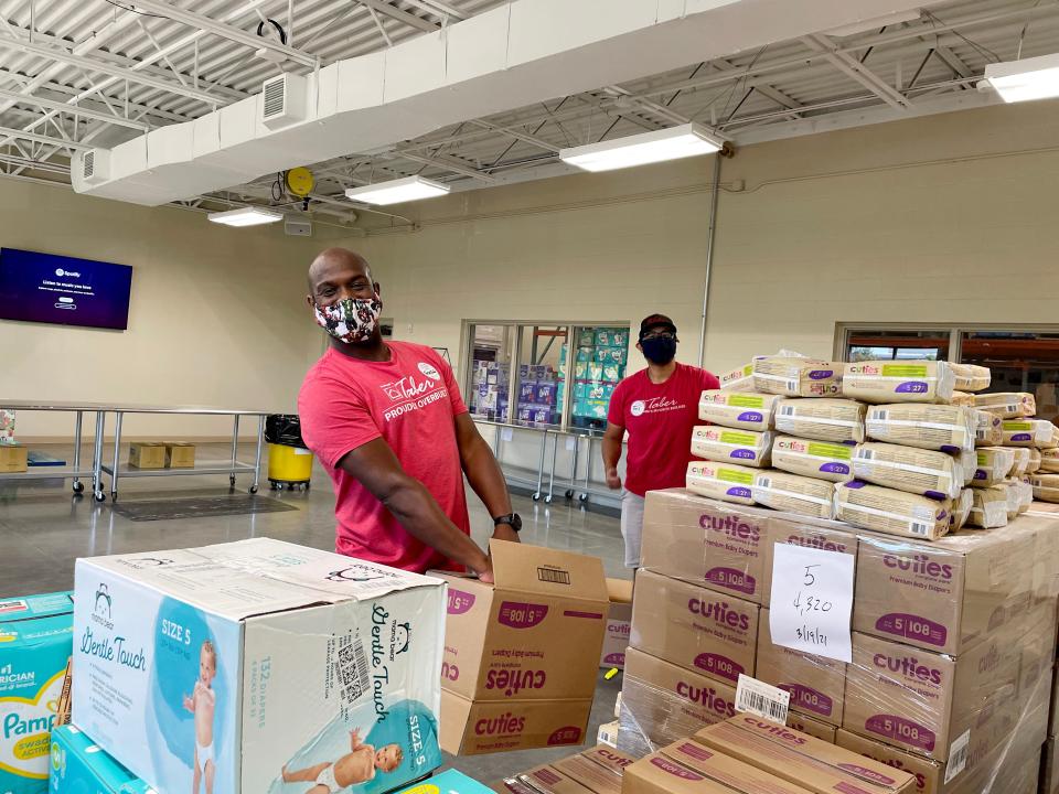 Frankie Lewis and Joel Filomeno, with Homes By Taber, volunteer at Infant Crisis Services.