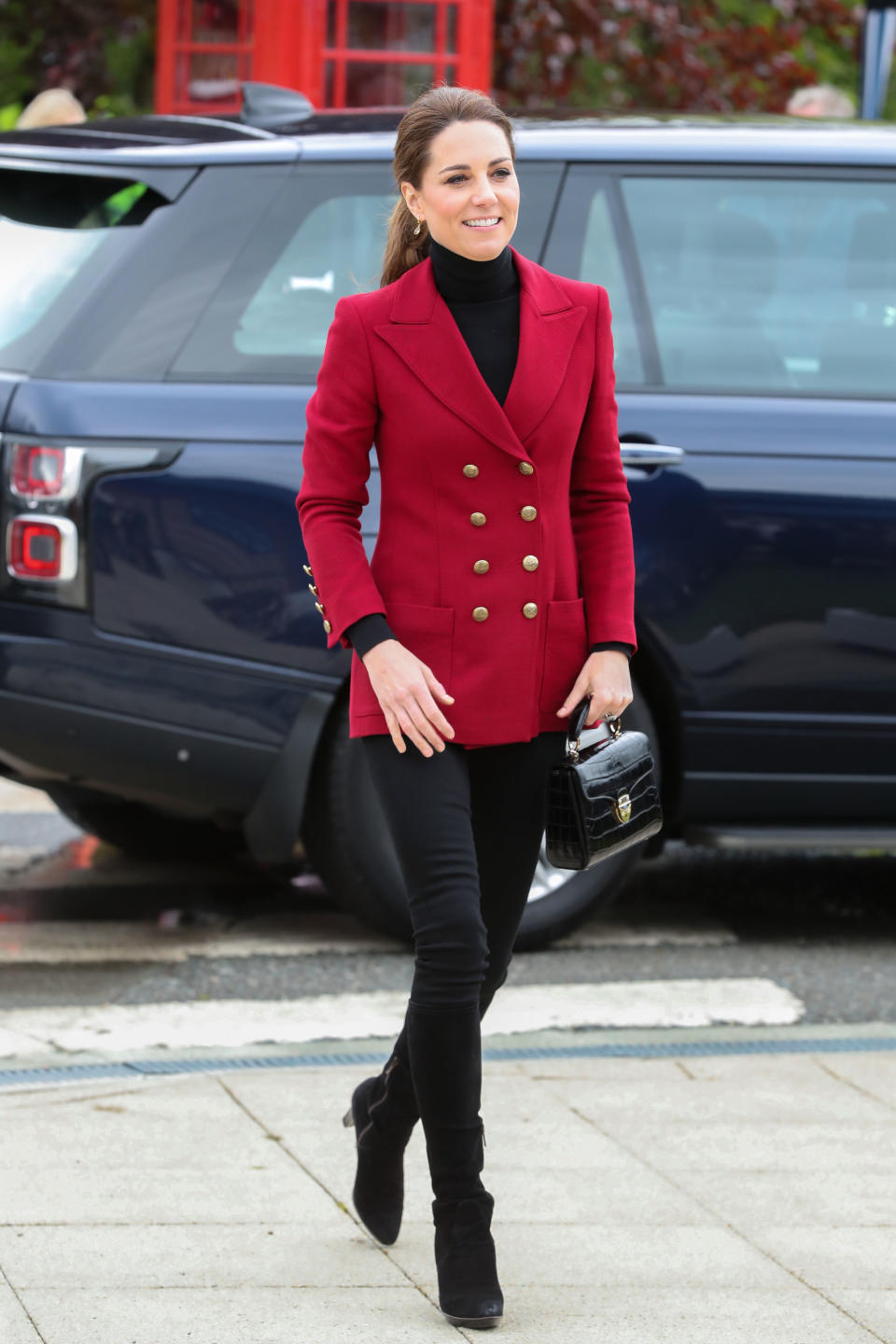 For a day of engagements in North Wales, Kate wore some old fashion favourites. She teamed her red Philosophy by Lorenzo Serafini blazer with a black roll neck and skinny jeans. She accessorised with her Aquatalia ‘Rhumba’ platform boots, her Aspinal Midi Mayfair bag and her Kiki McDonough citrine drop earrings. [Photo: Getty]