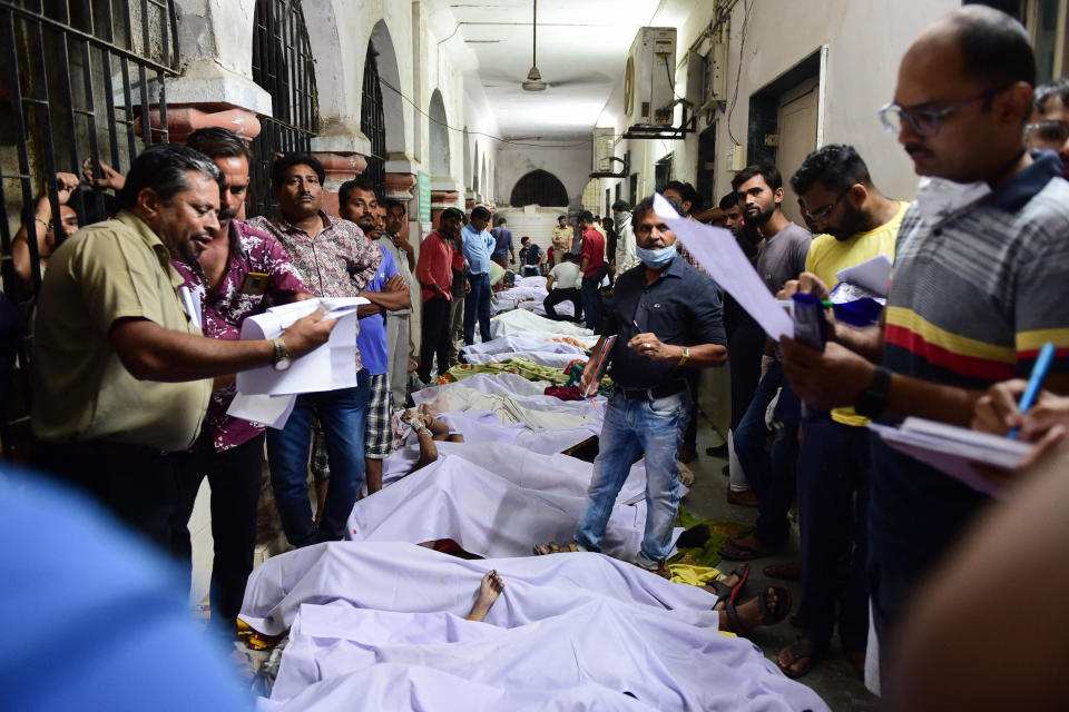 Bodies are seen on the floor of the government civil hospital after a bridge across the river Machchhu collapsed in Morbi, some 120 miles from Ahmedabad, early on October 31, 2022. / Credit: SAM PANTHAKY/AFP/Getty