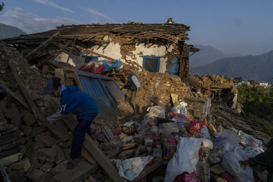 Survivors clear debris as they try to recover goods from damaged houses in Jajarkot district, northwestern Nepal, Sunday, Nov. 5, 2023. Friday night’s earthquake killed more than hundred people in the district while more than fifty were killed in the neighboring Rukum district, officials said. (AP Photo/Niranjan Shrestha)