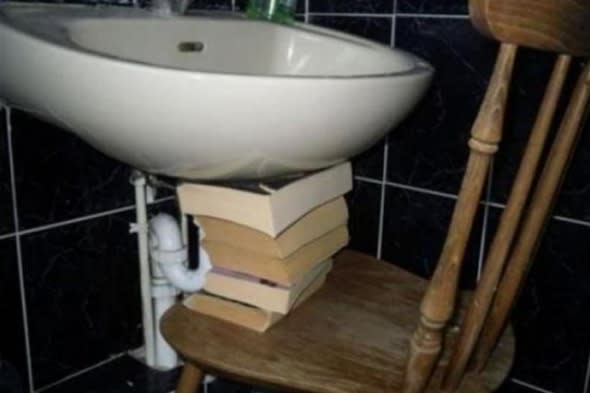 sink held up by stack of books