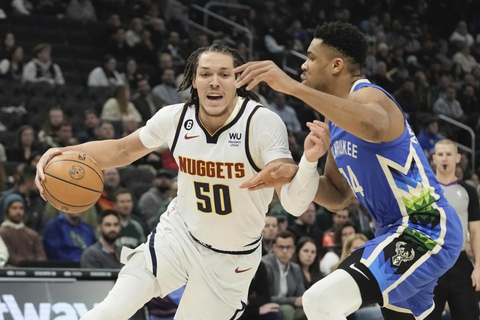 Tx50 drives past Milwaukee Bucks' Giannis Antetokounmpo during the first half of an NBA basketball game Wednesday, Jan. 25, 2023, in Milwaukee. (AP Photo/Morry Gash)