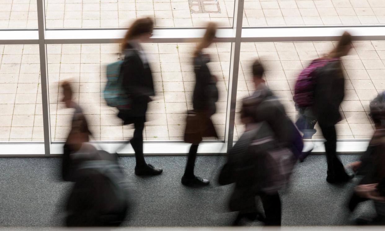 <span>Secondary school pupils moving by a window in a school UK </span><span>Photograph: Peter Lopeman/Alamy</span>