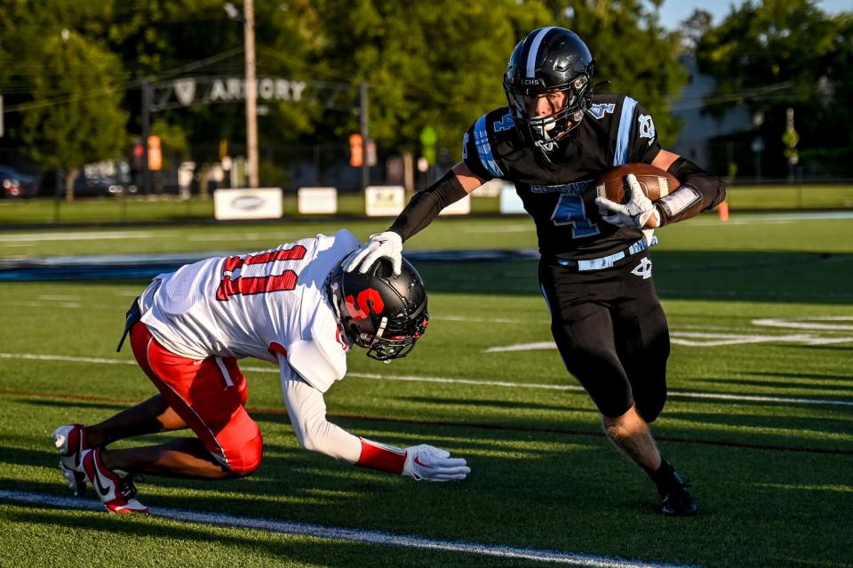 Lansing Catholic's Braden Rabideau, right, gets past Sexton's Devon Hodges during the first quarter on Thursday, Aug. 31, 2023, in Lansing.