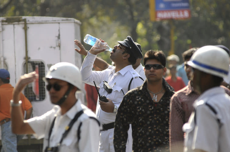 <span class="caption">A thirsty traffic police constable drinking water on a hot day Kolkata.</span>