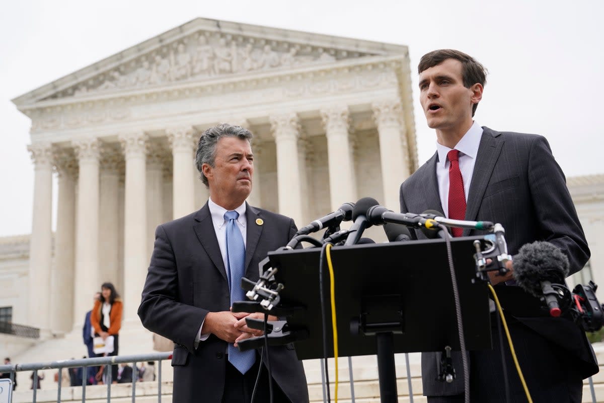 Alabama solictor general Edmund LaCour, right, and attorney general Steve Marshall address reporters after Supreme Court oral arguments in redistricting case last year (AP)