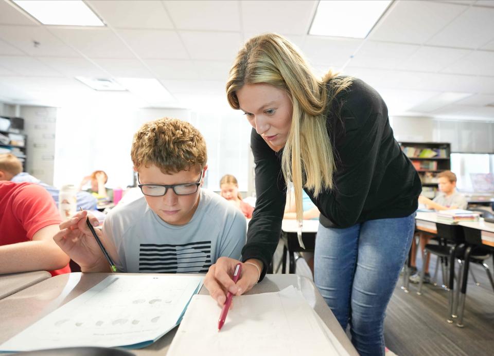 Ashley Joens, a student teacher and standout player on the Iowa State women's basketball team, helps fifth grader Kaden Sudbrock with fractions during class at Irving Elementary School in Indianola on Aug. 18.