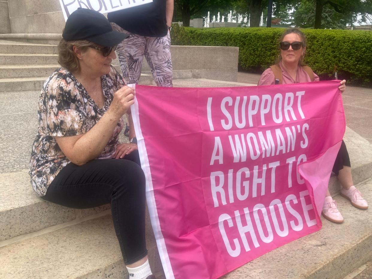 Kathleen Kimmel, left, and Vicky Gray, both from the Peoria area, hold a banner at the steps of the Lincoln statue in front of the Illinois Capitol building as part of the Pro Choice with Heart rally Sunday. The group coordinated rallies at state capitals across the nation on Sunday in the wake of a leaked opinion from U.S. Supreme Court Justice Samuel Alito in reference to Mississippi's challenge to Roe v. Wade. Many abortion-rights supporters believe the 1973 Supreme Court decision will be overturned.