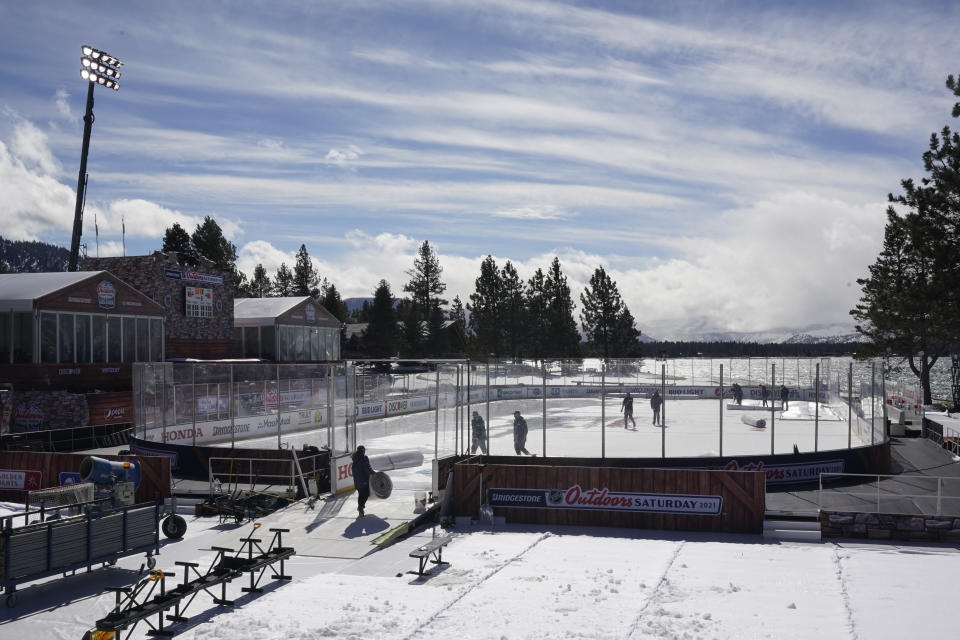 Workers put the finishing touches on the temporary ice rink, Friday, Feb. 19, 2021, built at the Edgewood Tahoe Resort, that will host two NHL games, this weekend at Stateline, Nev. The Colorado Avalanche will play the Vegas Golden Knights Saturday and the Philadelphia Flyers will face off against the Boston Bruins Sunday. (AP Photo/Rich Pedroncelli)