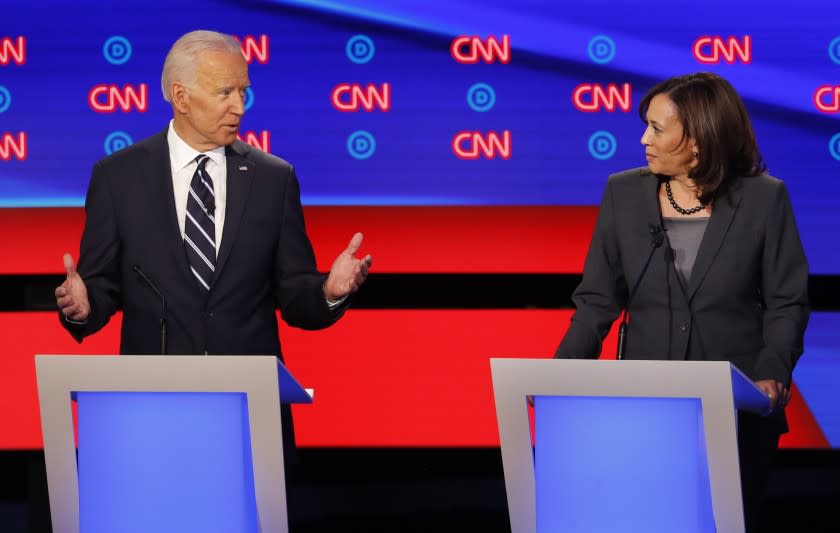 FILE - In this July 31, 2019 file photo, former Vice President Joe Biden speaks as Sen. Kamala Harris, D-Calif., listens during the second of two Democratic presidential primary debates hosted by CNN in the Fox Theatre in Detroit. As presumptive Democratic presidential nominee Joe Biden begins the process of choosing a running mate amid the coronavirus crisis, managing the pandemic has become its own version of an audition. For potential picks, lobbying for the job means breaking into the national conversation, positioning themselves as leaders and executing at their day job. (AP Photo/Paul Sancya)