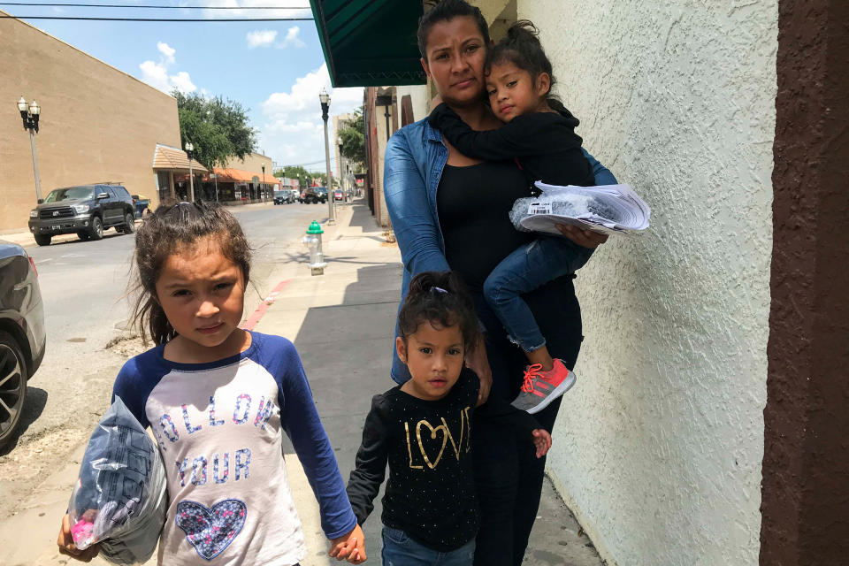 Silvia Guidel and her daughters Seily, 7, and twins Nahsliy Nicole and Nahsliy Dariana, 4, from Guatemala, make their way from the McAllen bus station to the Catholic Charities Humanitarian Respite Center on July 31, 2018.