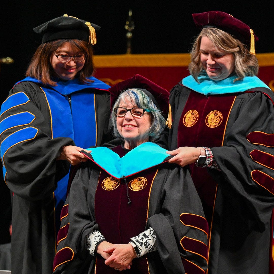 A recent SU Commencement graduate hooding ceremony.