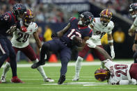 Houston Texans wide receiver Nico Collins (12) is stopped by Washington Commanders safety Bobby McCain (20) after a catch during the second half of an NFL football game Sunday, Nov. 20, 2022, in Houston. (AP Photo/Eric Christian Smith)