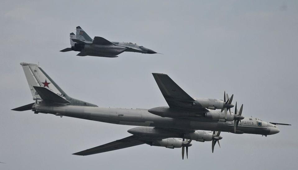 A Russian Tu-95 bear bomber and its escort fighter during an event in Russia.