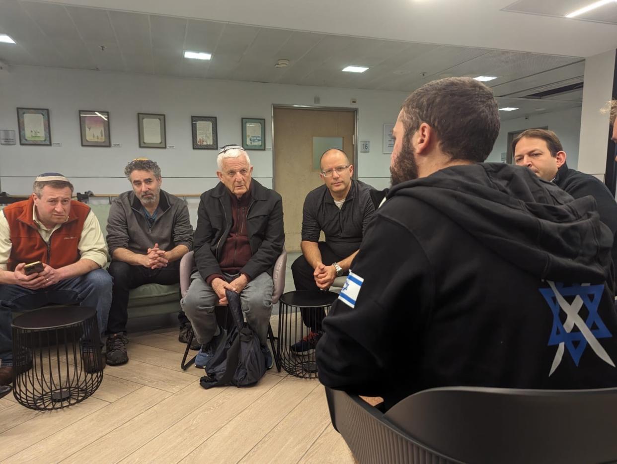 Visiting Israel, Rabbi Shalom Kantor, Rabbi Steven Rubenstein, Rabbi Harold Loss, Rabbi Daniel Schwartz, all from metro Detroit, and Rabbi Benjy Bar-Lev of Ohio (left to right), listen to a wounded Israeli soldier who was going through rehabilitation at Tel Aviv Sourasky Medical Center – Ichilov Hospital. The four rabbis were in Israel from Jan. 22-24 on a trip to support and comfort Israelis.