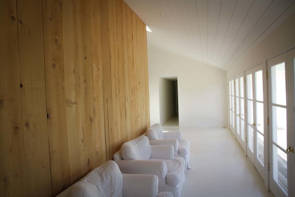 White, wood, and windows can be found throughout the space.