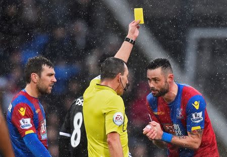 Football Soccer - Crystal Palace v Chelsea - Barclays Premier League - Selhurst Park - 3/1/16 Crystal Palace's Damien Delaney is shown a yellow card by referee Kevin Friend Reuters / Dylan Martinez Livepic