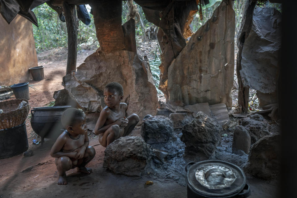 Children of Anayo Mbah wait to be bathed at their home in Umuida, Nigeria, Saturday, Feb. 12, 2022. Mbah was in the final days of her sixth pregnancy when her husband, Jonas, fell ill with fever. By the time he was taken to a clinic, the motorcycle taxi driver was coughing up blood. He tested positive for COVID-19 and was still in the hospital when she gave birth days later. The baby would never meet her father. (AP Photo/Jerome Delay)