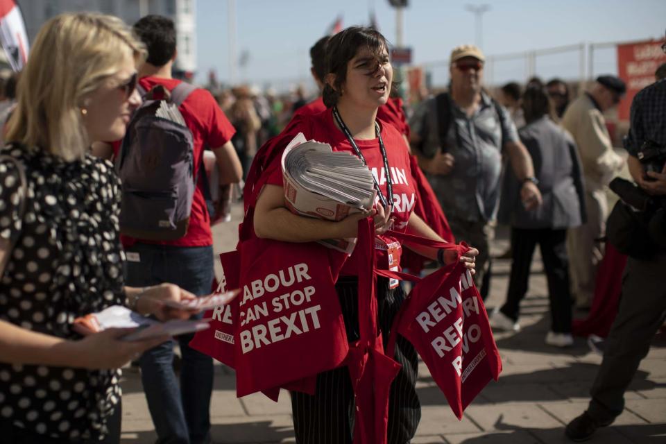 Labour activists hand out bags that read 