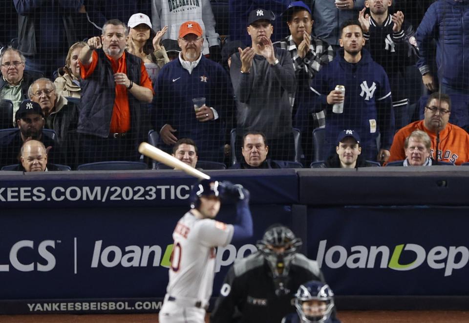 United States Senator Ted Cruz of Texas (top-L) stands during a Houston Astros at bat against the New York Yankees in the fourth game of the American League Championship Series between the Houston Astros and the New York Yankees at Yankee Stadium in the Bronx borough of New York, New York, USA, 23 October 2022. MLB Houston Astros at New York Yankees, USA - 23 Oct 2022