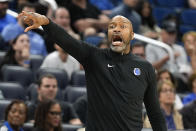 Orlando Magic coach Jamahl Mosley shouts to players during the first half of the team's NBA basketball game against the Brooklyn Nets, Wednesday, March 13, 2024, in Orlando, Fla. (AP Photo/John Raoux)