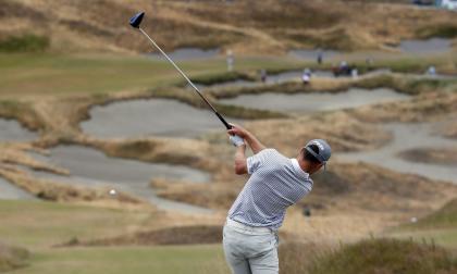 Amateur Brian Campbell watches his tee shot on the fourth hole during the first round of the U.S. Open. (AP)