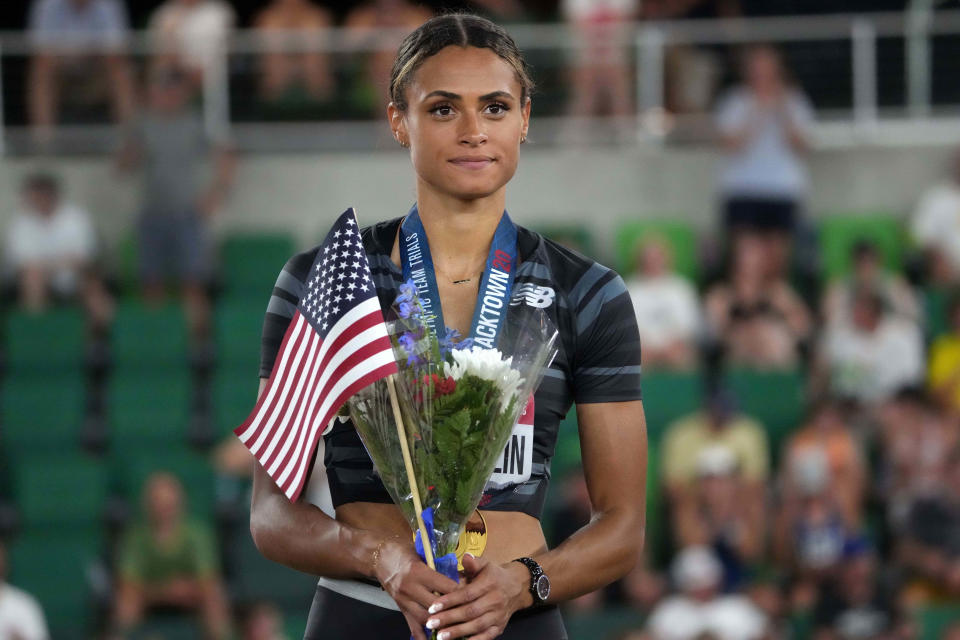 Sydney McLaughlin poses with gold medal after winning the women's 400m hurdles in a world-record 51.90 during the US Olympic Team Trials at Hayward Field.