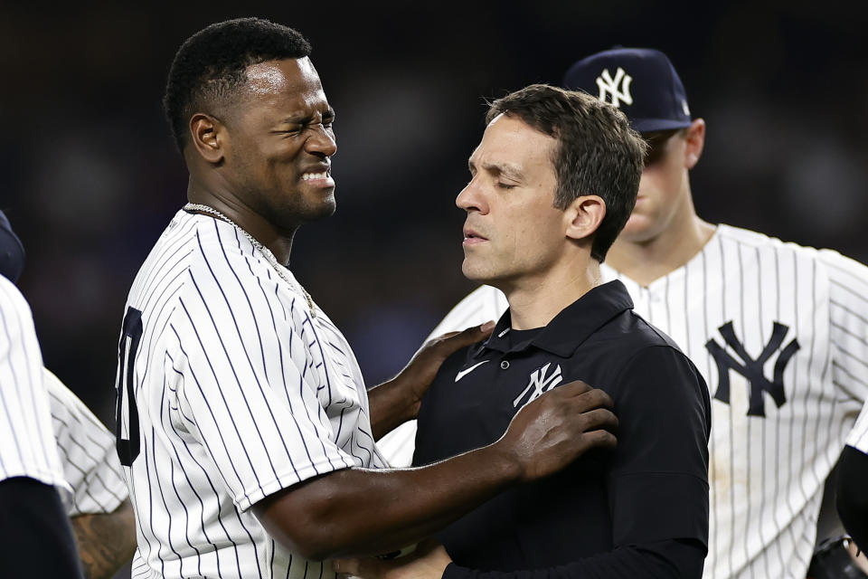 New York Yankees pitcher Luis Severino, left, reacts as he is checked by a trainer during the fifth inning of a baseball game against the Milwaukee Brewers, Friday, Sept. 8, 2023, in New York. (AP Photo/Adam Hunger)