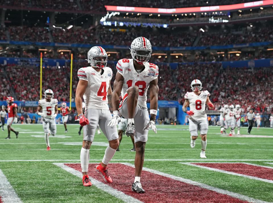 Dec 31, 2022; Atlanta, Georgia, USA; Ohio State Buckeyes wide receiver Marvin Harrison Jr. (18) celebrates his touchdown catch against Georgia Bulldogs during the first quarter of the Peach Bowl in the College Football Playoff semifinal at Mercedes-Benz Stadium. 