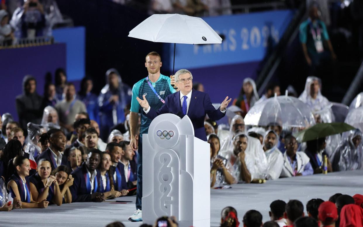 Thomas Bach greets the athletes and millions around the world watching