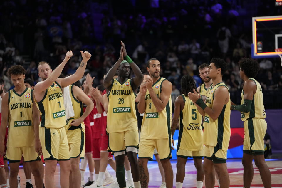 Australia team members celebrate after they defeated Georgia in their Basketball World Cup group K match in Okinawa, southern Japan, Sunday, Sept. 3, 2023. (AP Photo/Hiro Komae)