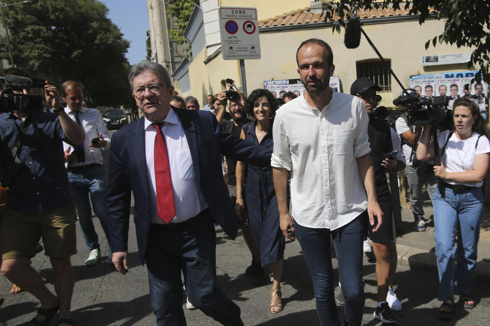 Hard-left leader Jean-Luc Melenchon, left, and Manuel Bompard leave after voting Sunday, June 19, 2022 in Marseille, southern France. French voters are going to the polls in the final round of key parliamentary elections that will demonstrate how much legroom President Emmanuel Macron's party will be given to implement his ambitious domestic agenda. (AP Photo)