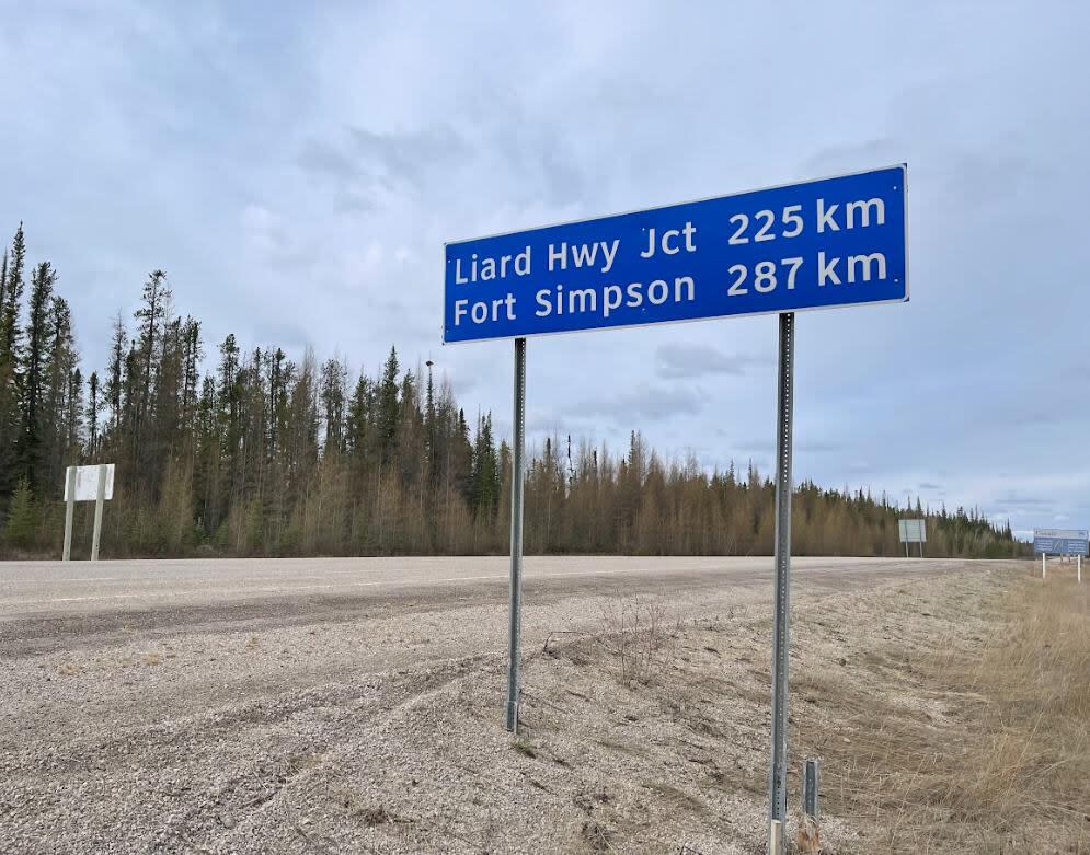 A photo of a road sign along the N.W.T. Highway 1. Road access to the communities of Fort Simpson and Fort Liard are being threatened by wildfires.  (Robert Holden/CBC - image credit)
